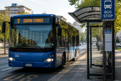Autobus urbano alla fermata del bus in una città italiana durante il giorno